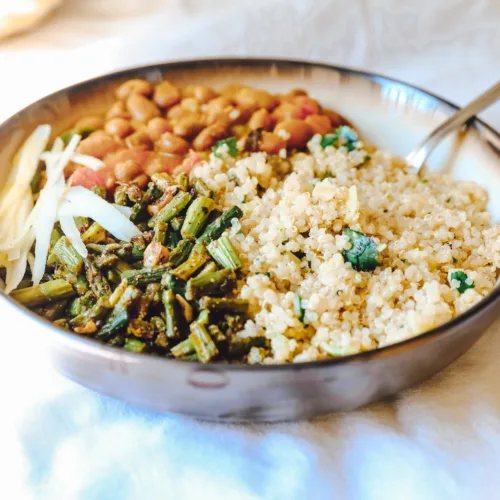 cooked rice with green peas and carrots on stainless steel bowl