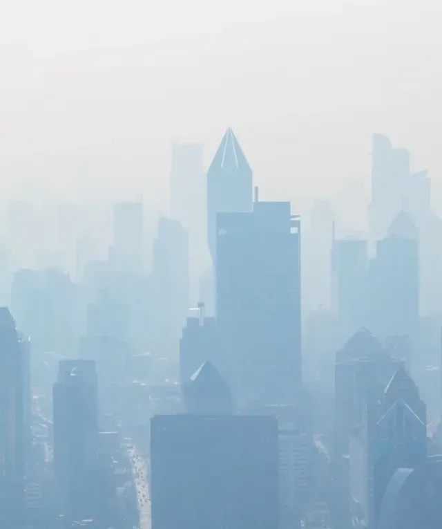 aerial view of high-rise buildings covered with smoke